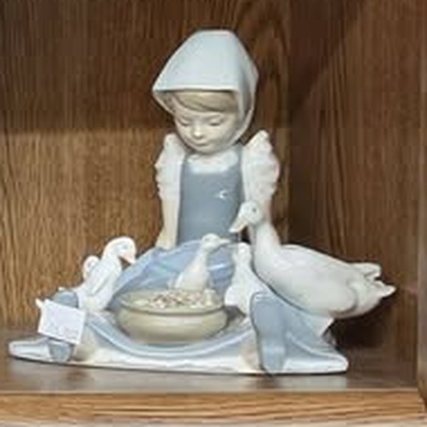 Lladro porcelain figurine of a girl in a headscarf feeding geese, available at Once More Corner Store