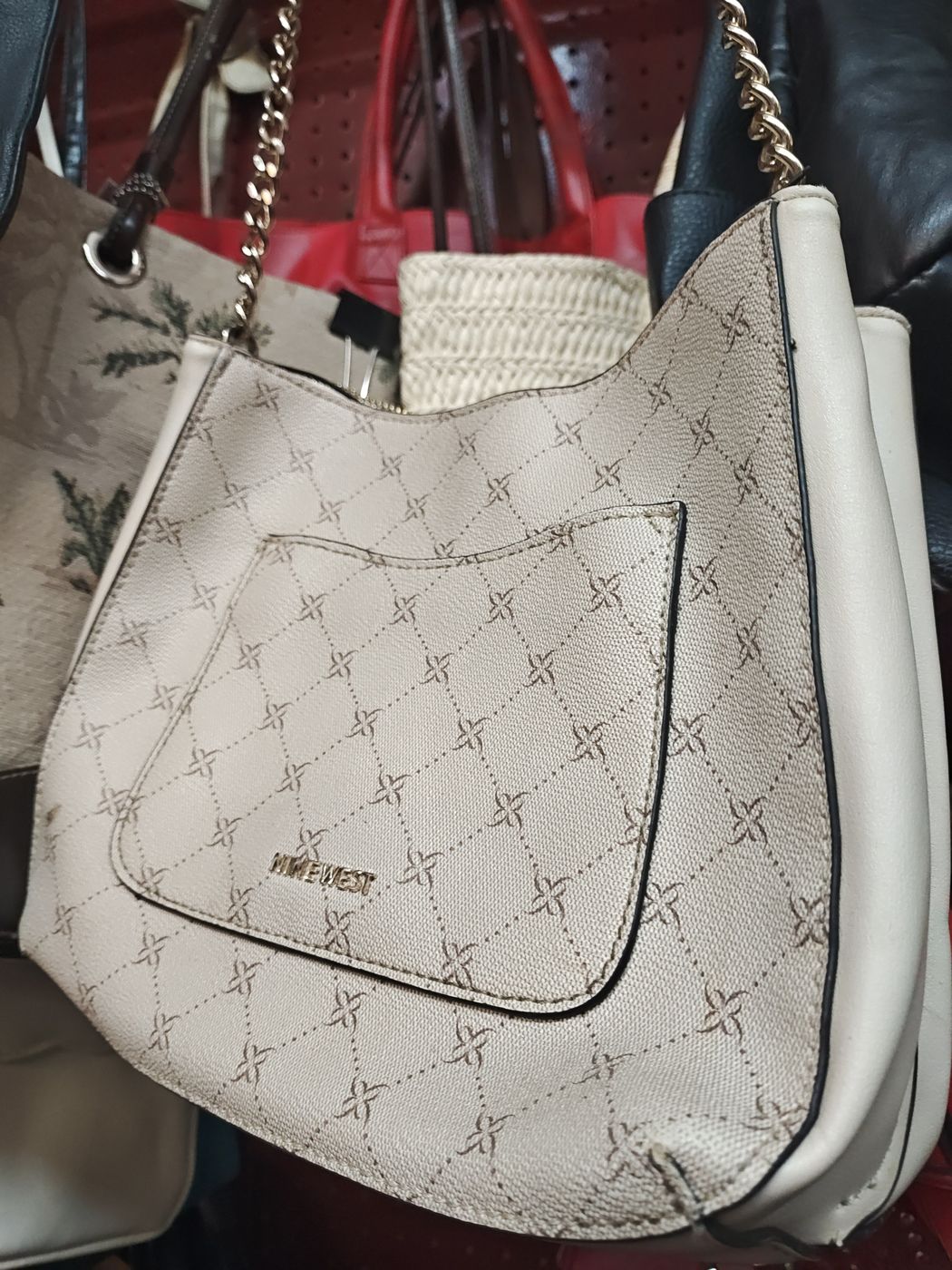 Cream Nine West hobo bag with a chain strap