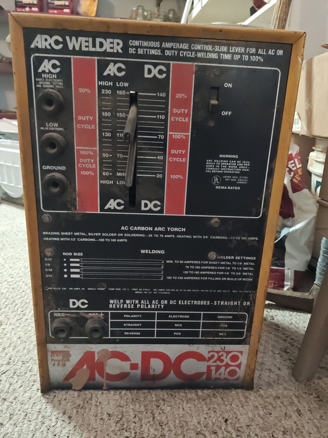 AC/DC arc welder with its settings chart on the front panel